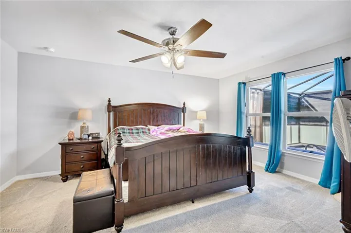 Bedroom featuring light carpet and ceiling fan