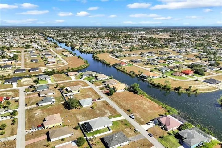 View of property location with nearby suburban area and a large body of water