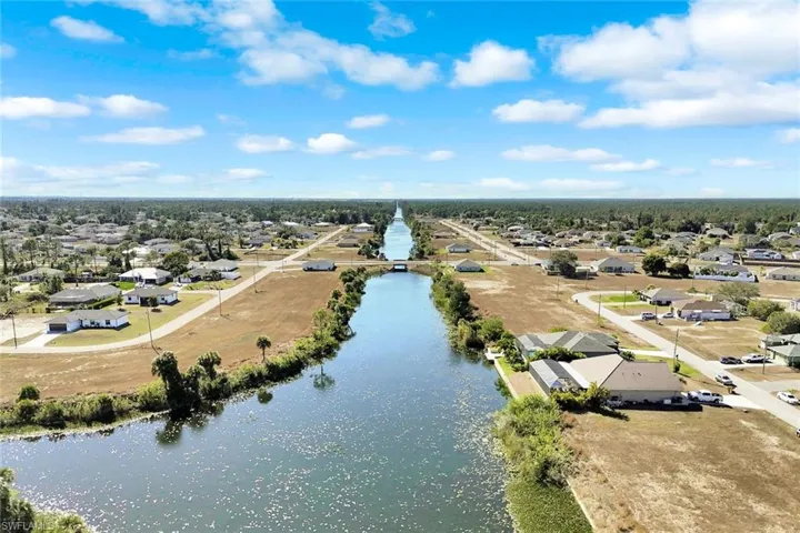 Aerial view of residential area featuring a large body of water
