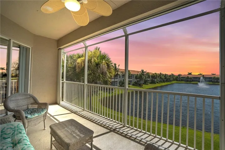 Sunroom / solarium with a water view and ceiling fan