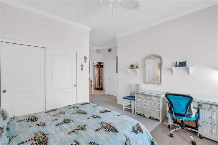 Bedroom featuring crown molding, light colored carpet, a closet, and ceiling fan
