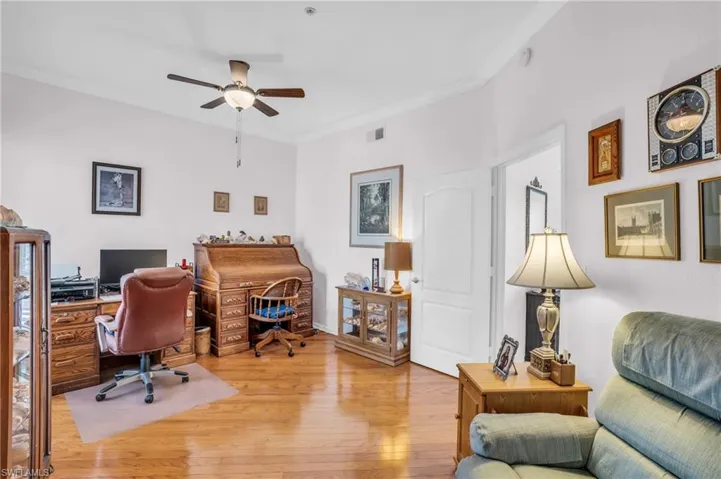 Office featuring ornamental molding, hardwood / wood-style flooring, and ceiling fan