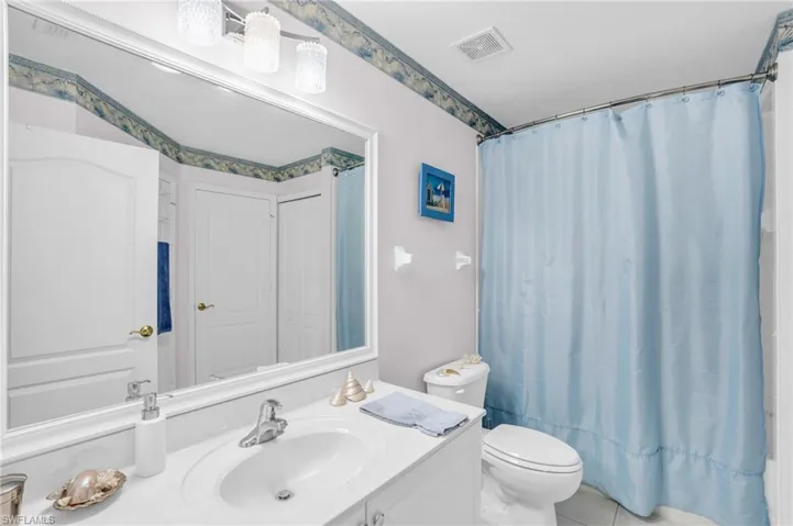 Bathroom with tile patterned floors, vanity, and toilet