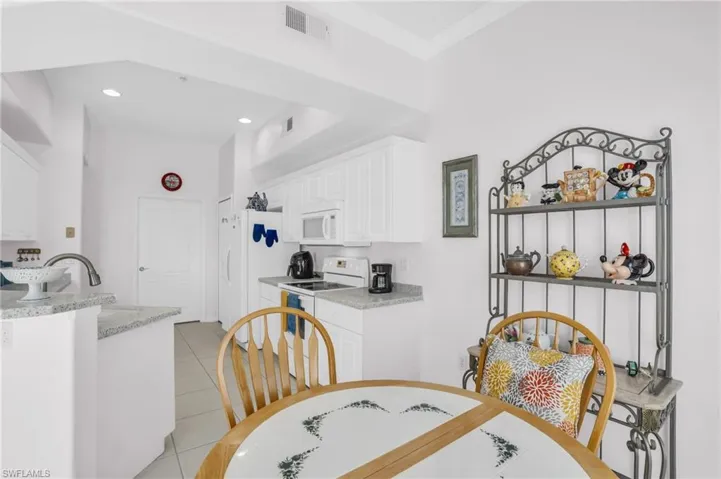 Dining area featuring light tile patterned flooring and sink