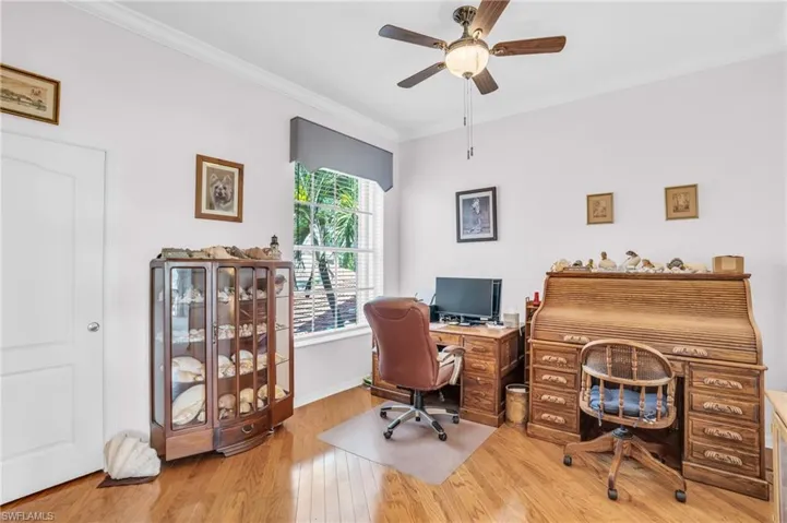 Office space featuring light hardwood / wood-style floors, ornamental molding, and ceiling fan
