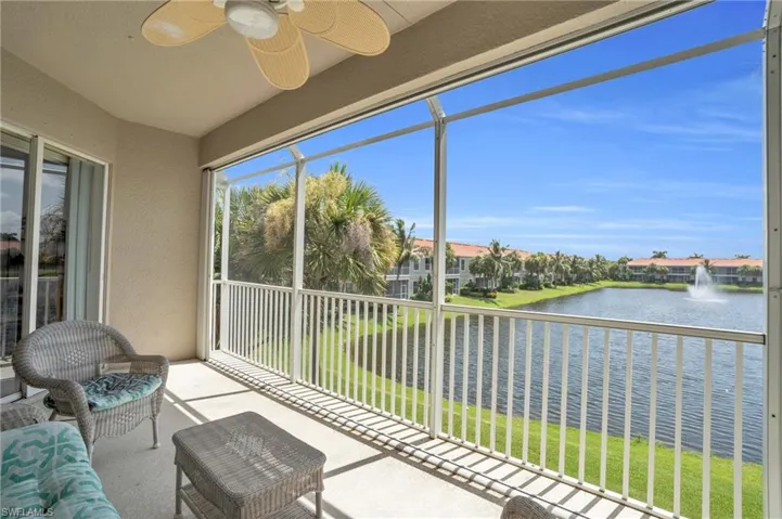 Unfurnished sunroom with a water view and ceiling fan