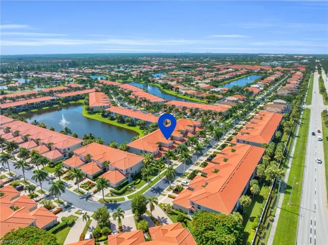 Birds eye view of property with a water view