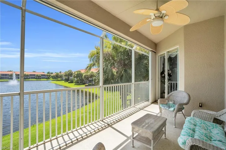 Unfurnished sunroom featuring a water view and ceiling fan