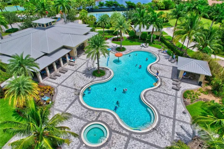 View of swimming pool featuring a community hot tub and a patio area
