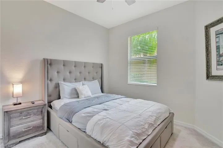 Carpeted guest bedroom with ceiling fan