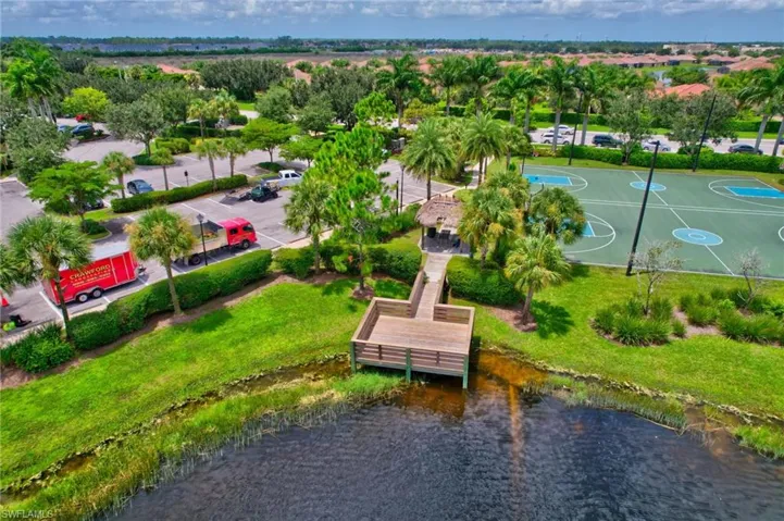 Aerial view featuring a water view of fishing pier