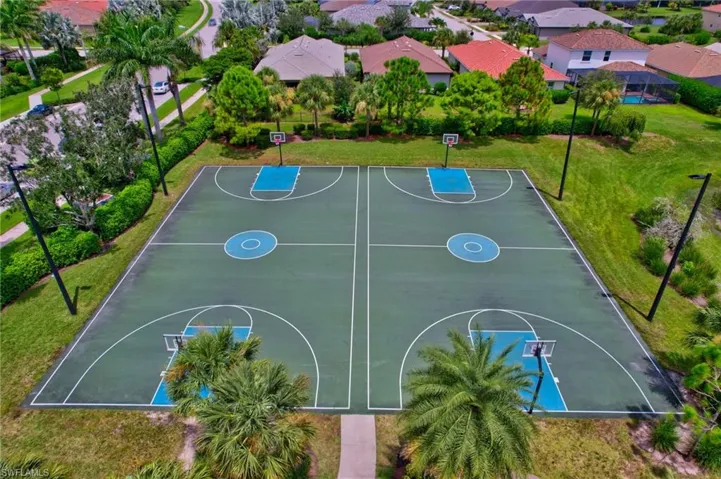 View of basketball court with a yard