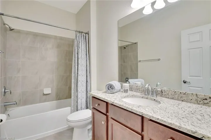 Full guest  bathroom with tile & granite