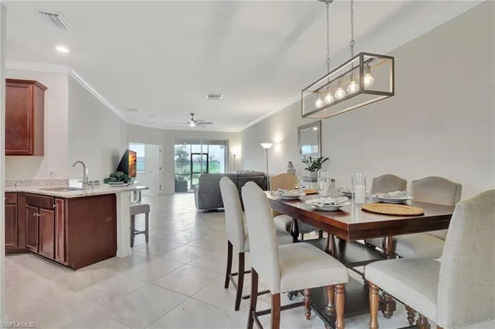 Tiled dining area with crown molding,