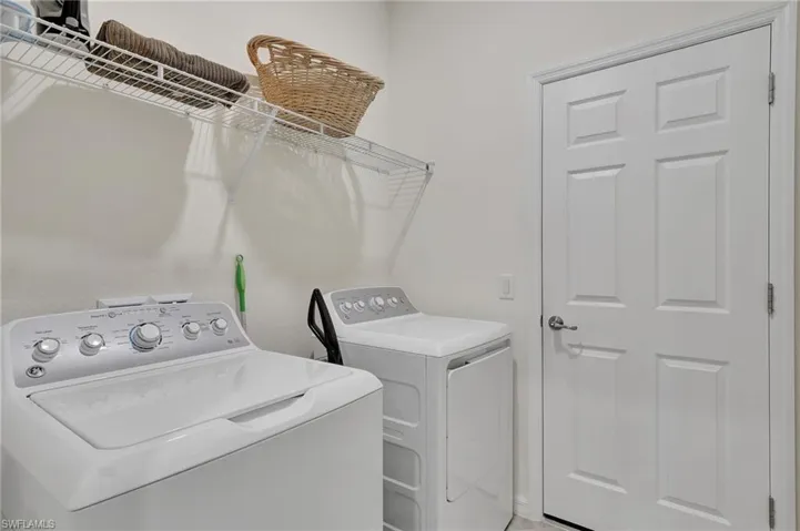 Clothes washing area featuring independent washer and dryer