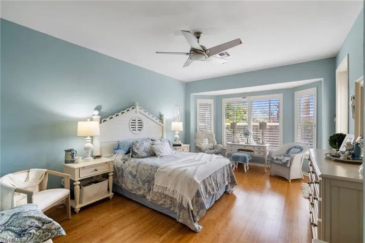 Bedroom featuring light hardwood / wood-style floors and ceiling fan