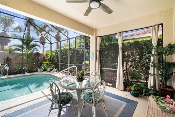 View of pool featuring ceiling fan, a patio area, and a lanai