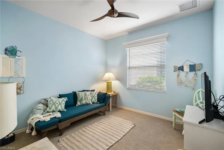 Living room featuring carpet and ceiling fan
