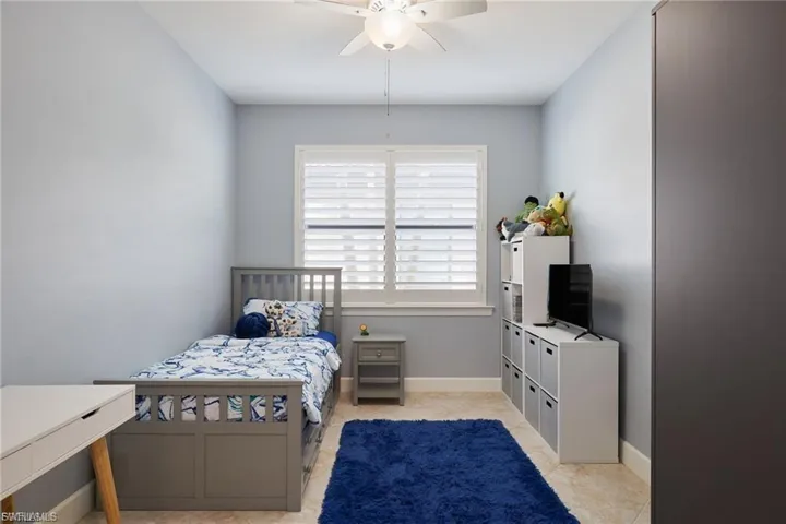 Bedroom featuring a ceiling fan and light tile patterned floors