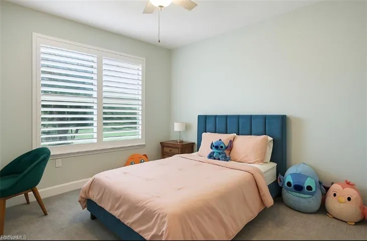 Bedroom with carpet floors and a ceiling fan