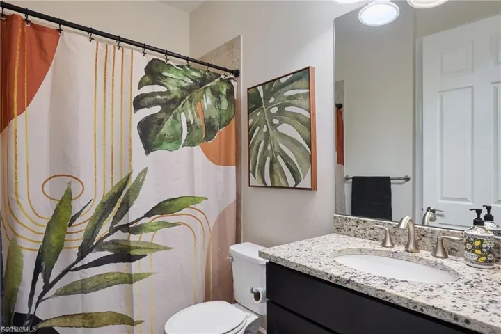 Bathroom with vanity and a shower with curtain