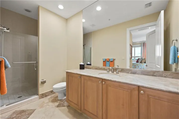 En suite guest bath with large vanity and walk-in shower.