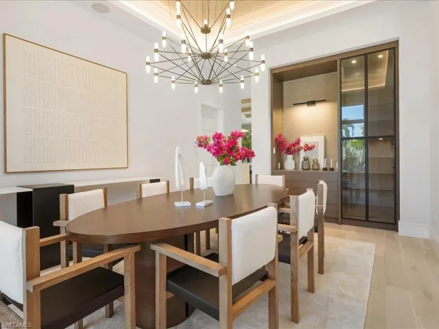 Dining area with a notable chandelier and light wood-style floors