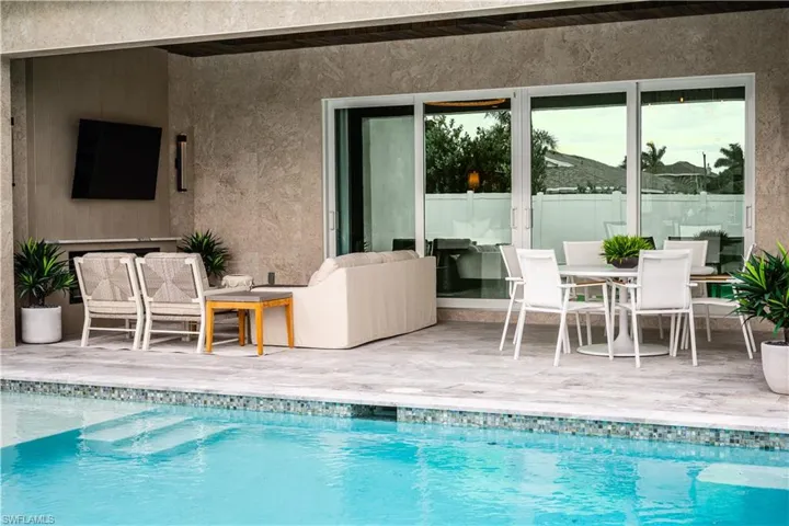 View of swimming pool with a patio, outdoor dining area, and an outdoor hangout area