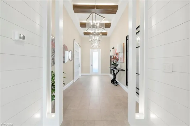 Living room featuring a chandelier and a raised ceiling