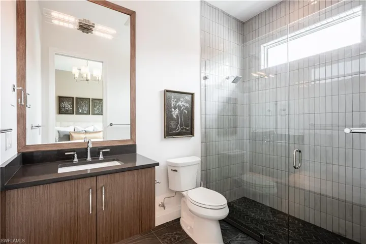 Full bath featuring vanity, ensuite bath, and a shower stall
