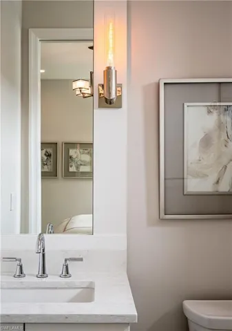 Half bathroom featuring vanity and ensuite bathroom
