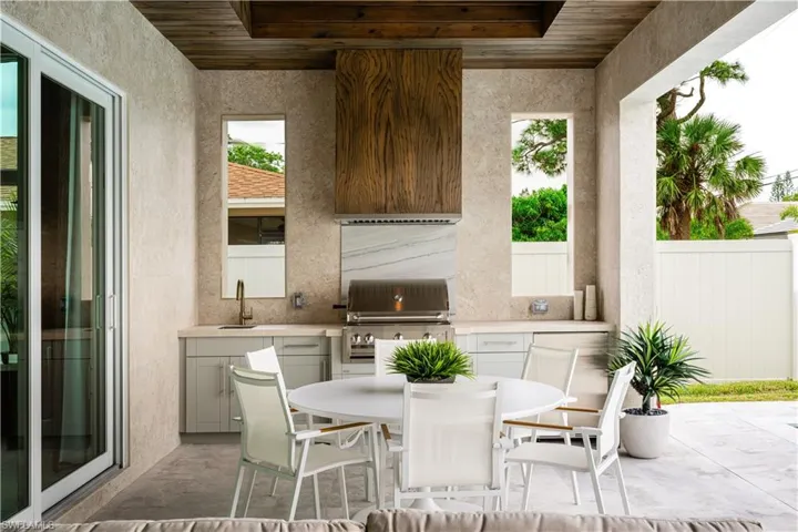 View of patio with an outdoor kitchen and outdoor dining space