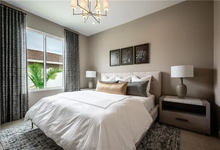 Bedroom with a chandelier and recessed lighting