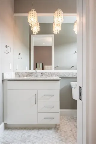 Bathroom featuring vanity and a chandelier