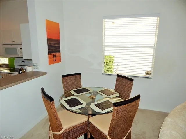 Dining room featuring carpet and baseboards