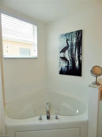 Full bathroom featuring a bath