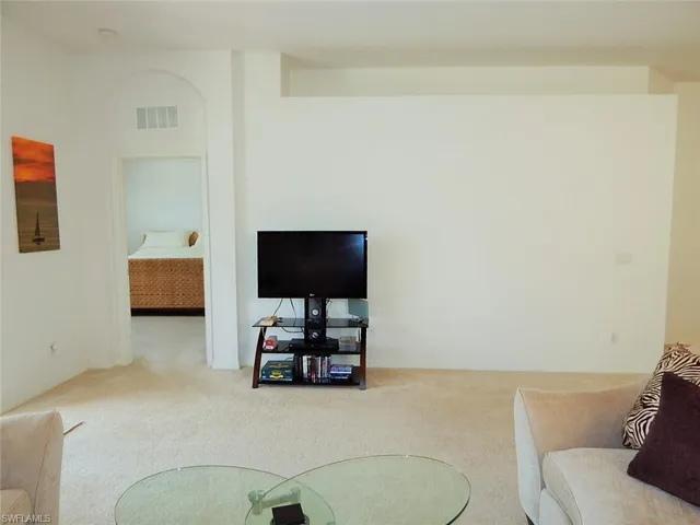Carpeted living room featuring baseboards