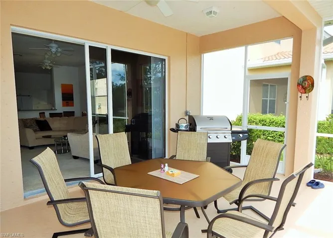 View of patio / terrace with ceiling fan, area for grilling, and outdoor dining area