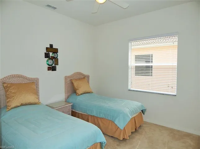 Bedroom featuring light carpet and ceiling fan