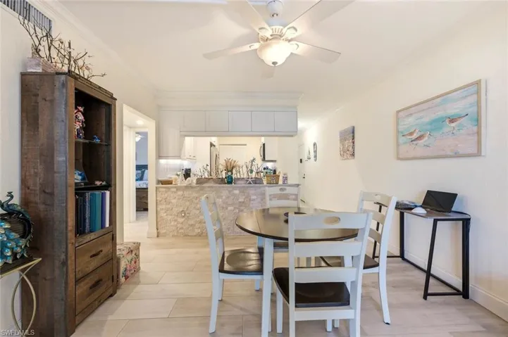 Dining area featuring crown molding and a ceiling fan