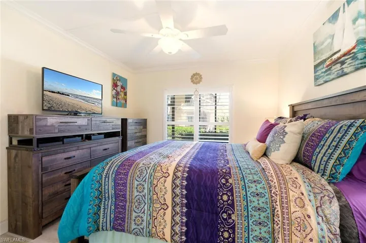 Bedroom featuring ornamental molding and a ceiling fan