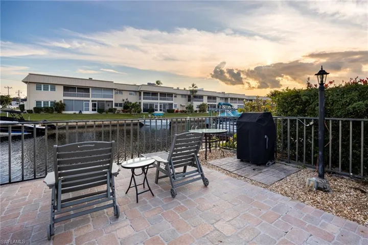 View of patio featuring a grill and a water view