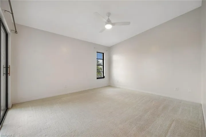 Unfurnished room with light colored carpet and ceiling fan