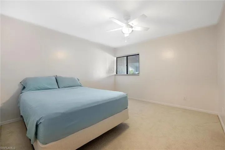 Bedroom with light carpet and ceiling fan