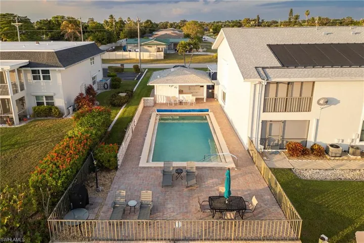 View of pool with a patio area, outdoor dining area, and a fenced backyard