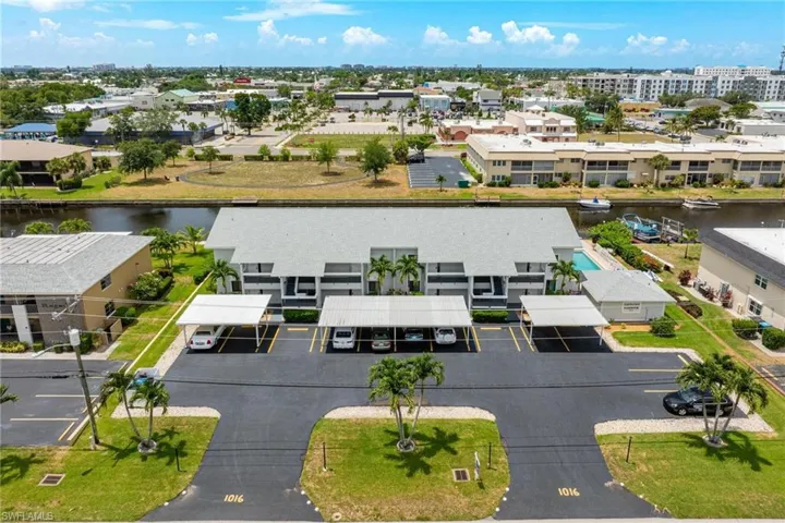 Aerial view of a nearby body of water and apartment complex / building