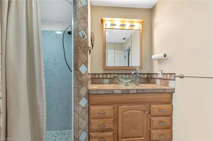 Bathroom with vanity and walk in shower