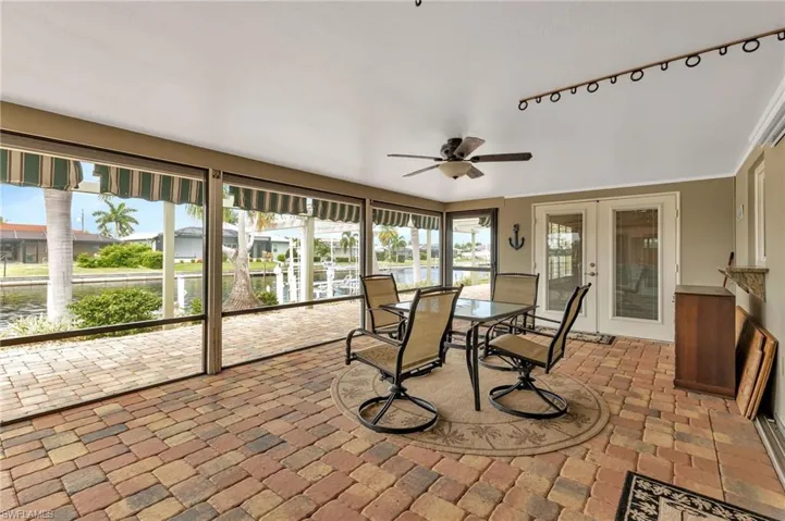 Sunroom / solarium with ceiling fan and french doors