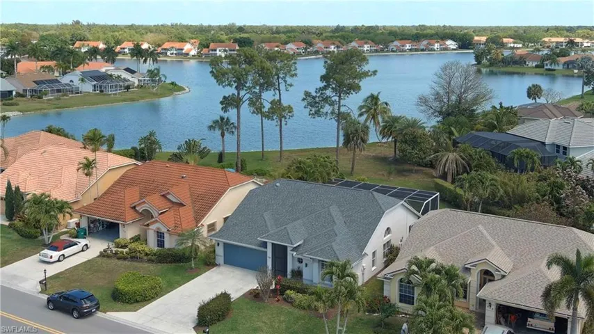 Aerial perspective of suburban area with a nearby body of water