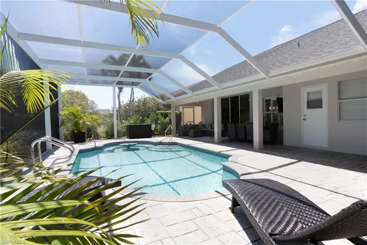 Outdoor pool with a sunroom, a patio, and a lanai